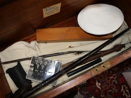 A naval trunk containing a naval cap, epaulettes, a nautical ruler, sword stick and truncheon.